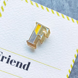 enamel letter F pin badge with card