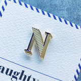 enamel pin badge with letter N and card
